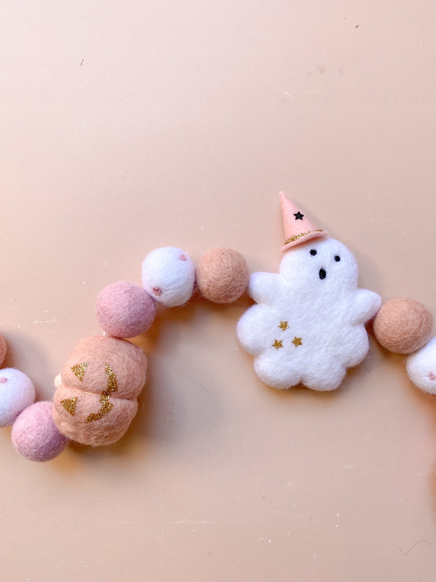 halloween felt garland with ghost, witch hat, pumpkins in soft pink colour