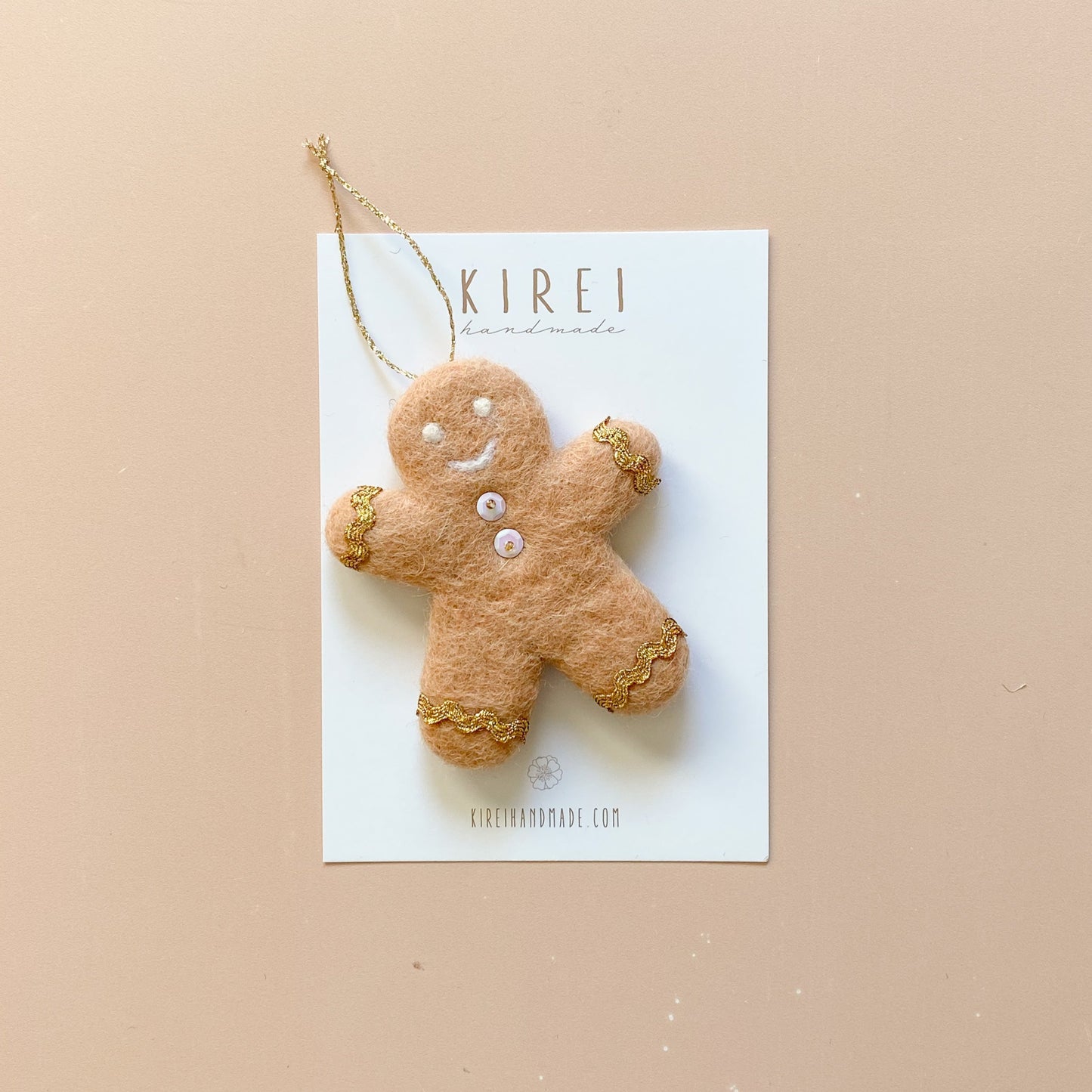 A felt gingerbread man ornament with round buttons