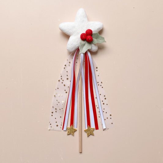 Decorative wand with star, red berries, holly leaves and ribbons 