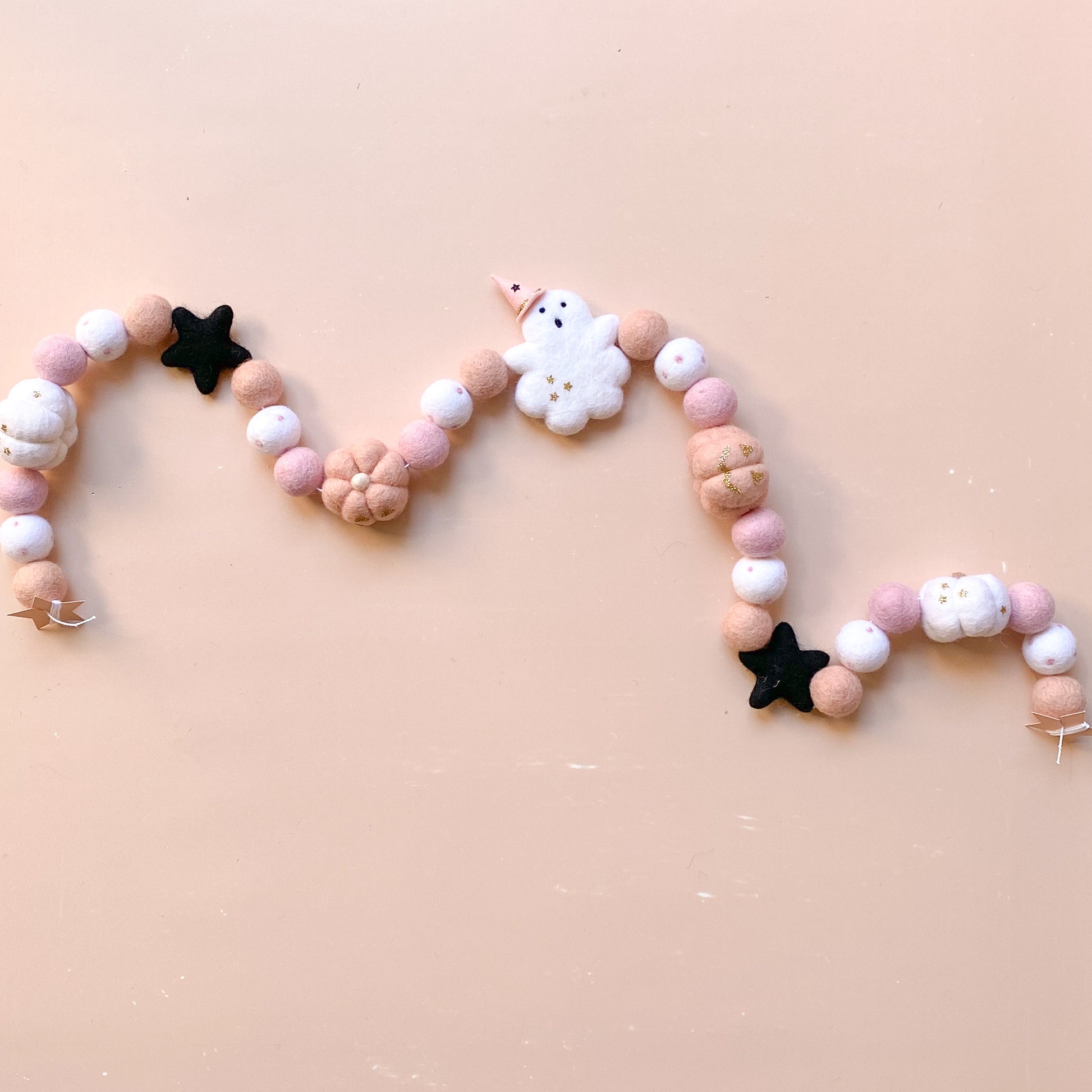halloween felt garland with ghost, witch hat, pumpkins in soft pink colour