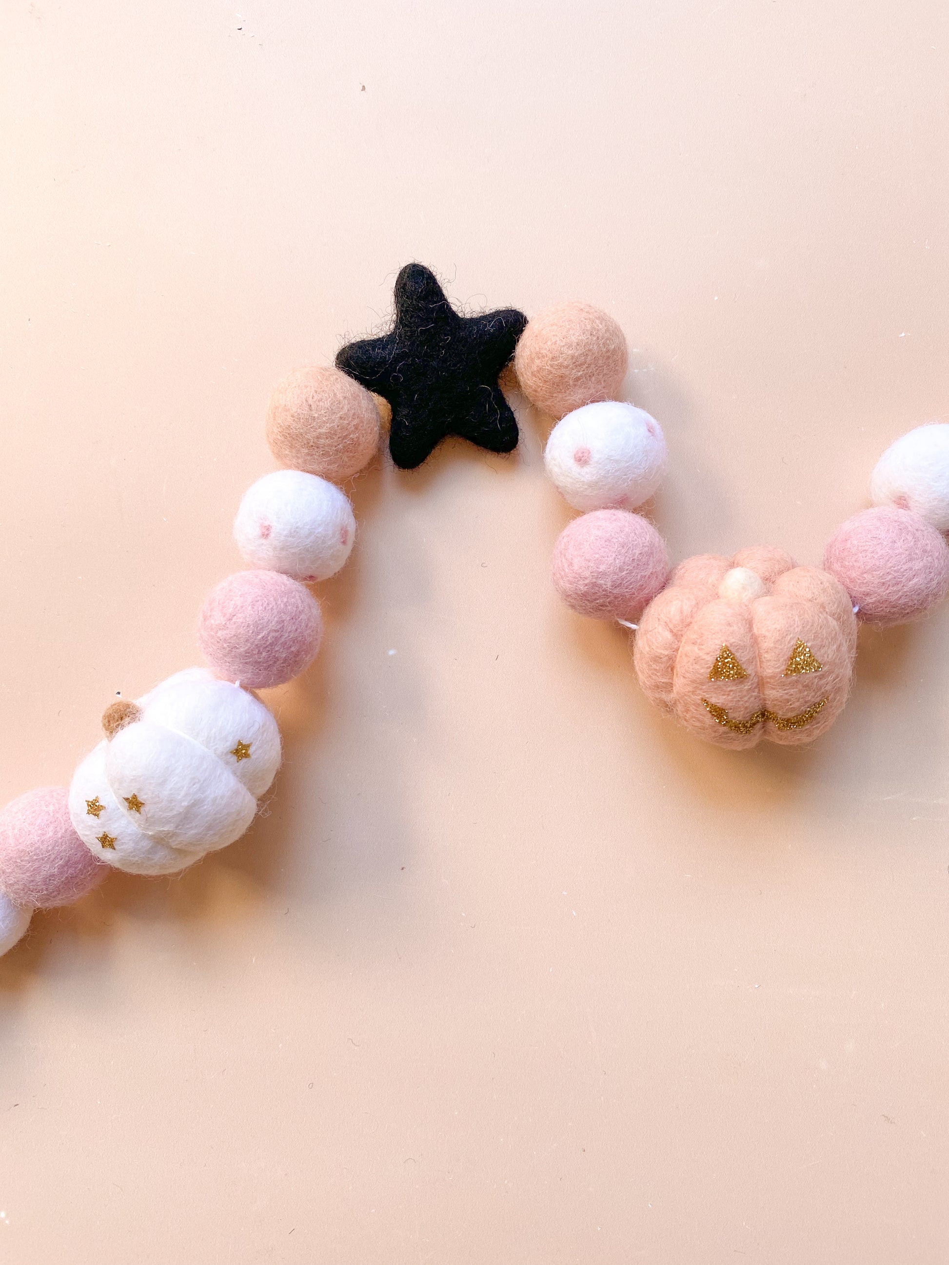 halloween felt garland with ghost, witch hat, pumpkins in soft pink colour