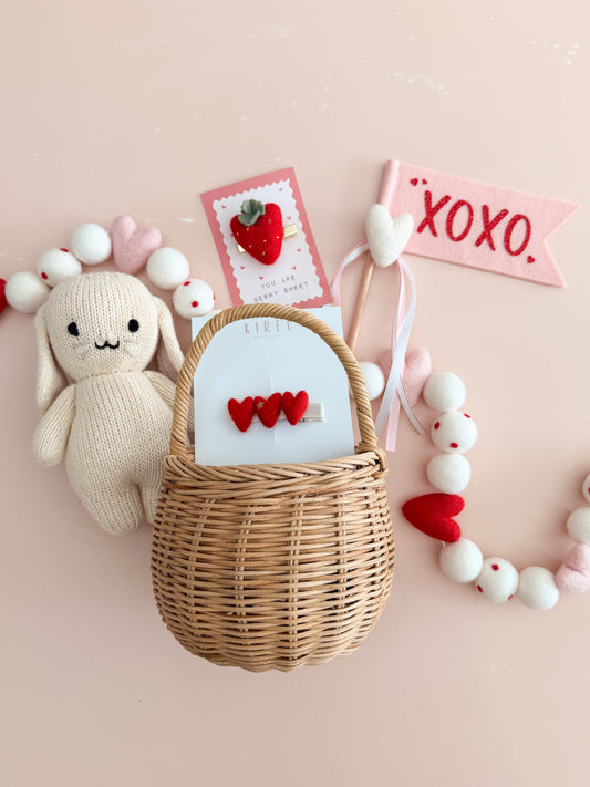 Valentine's Day basket suggestion including Cuddle and Kind plush toy, and heart-themed accessories and decor