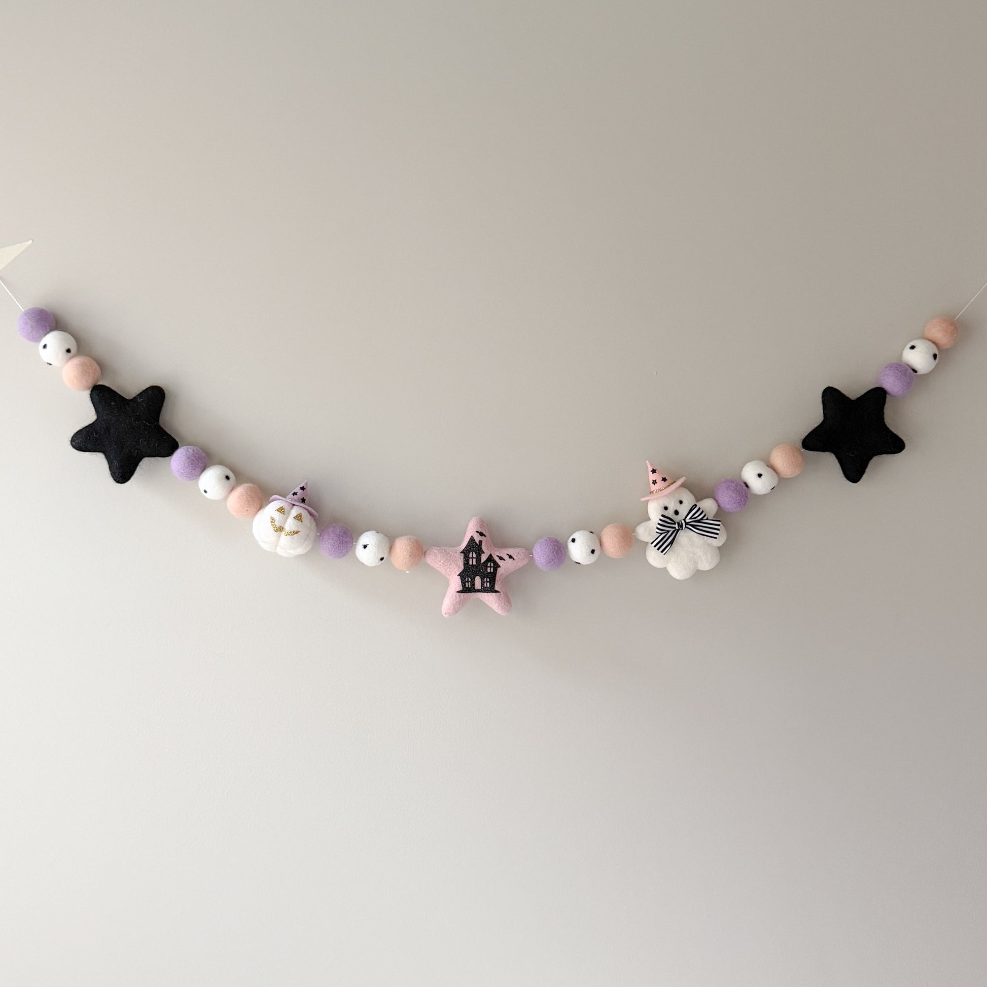 A pastel-colored halloween felt garland 