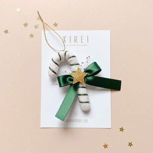 Decorative candy cane ornament with green ribbon and gold star 